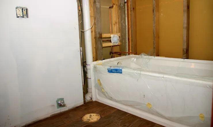 Bathroom remodeling in Los Angeles with bathtub installation, plumbing upgrades, wall preparation, and renovation work in progress