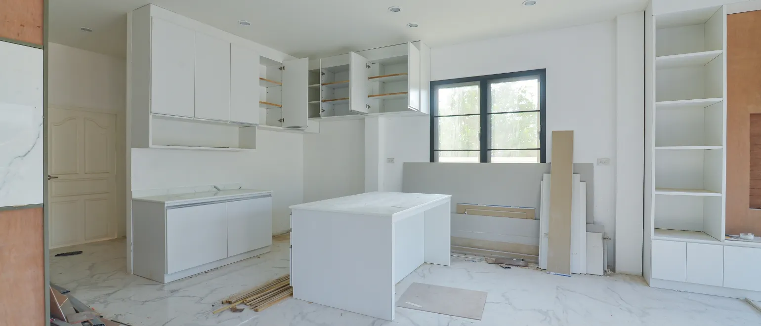Luxury home remodeling in Los Angeles with custom white kitchen cabinets, modern island, marble-look flooring, built-in storage, and premium interior renovation