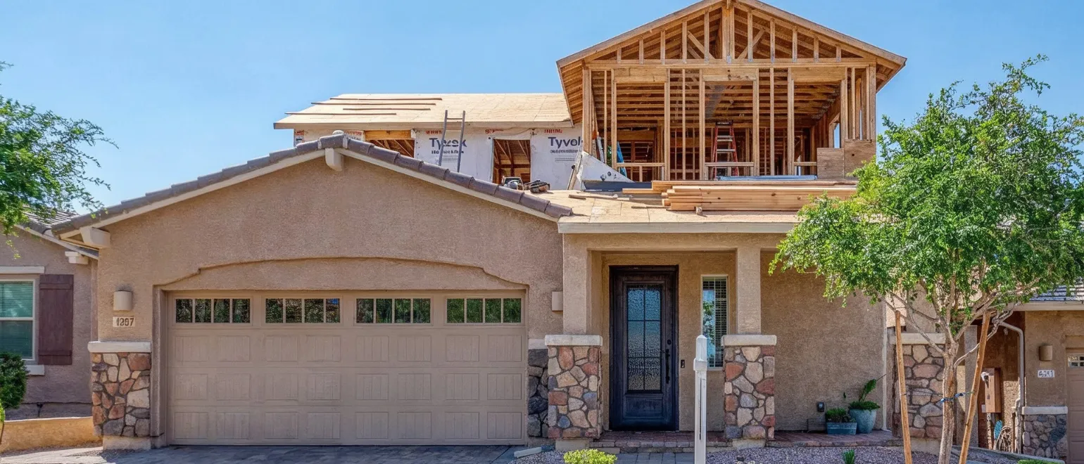 Room addition construction in Los Angeles with second-story framing, roof expansion, and home exterior buildout in progress