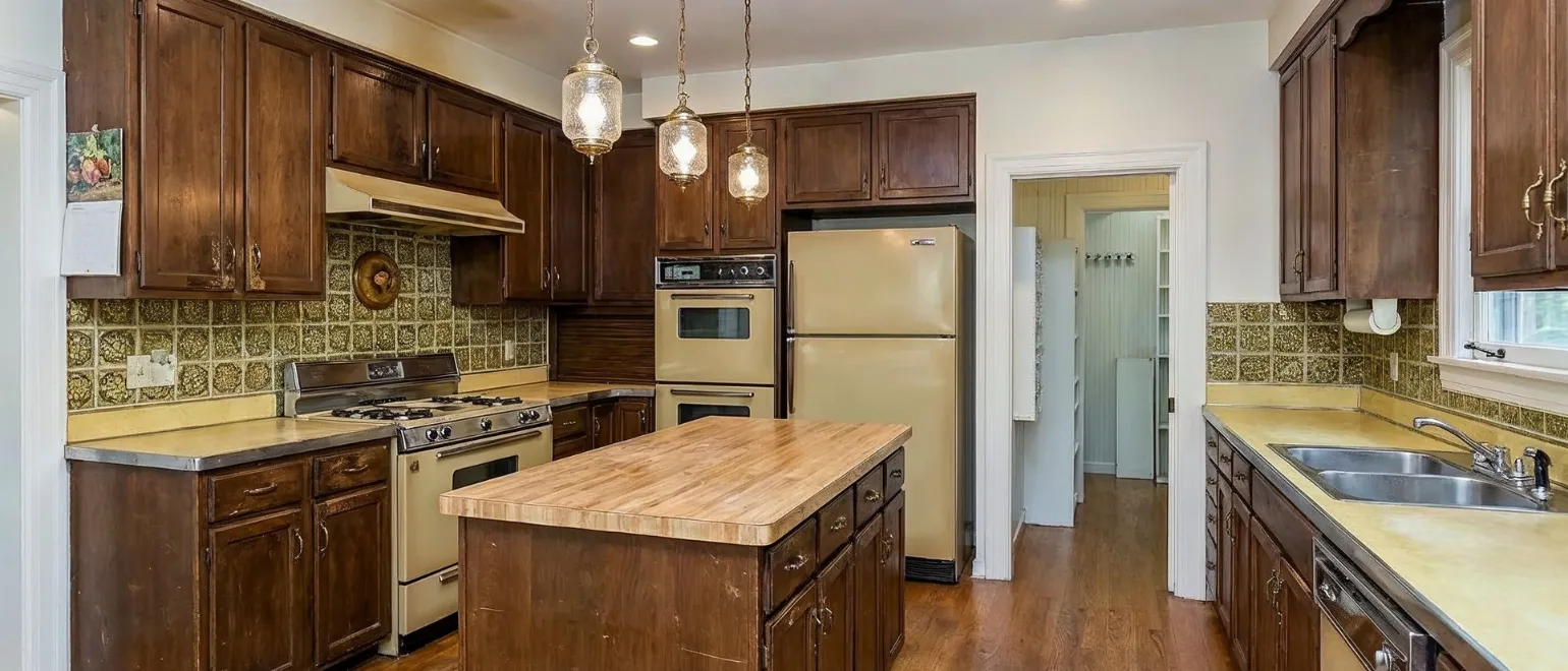 Before kitchen remodeling project in Los Angeles showing outdated wood cabinets, old appliances, worn countertops, poor lighting, and inefficient kitchen layout